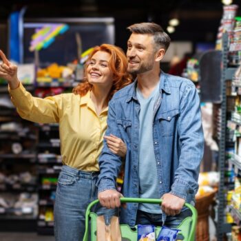 Couple looking at food in supermarket 2474899423