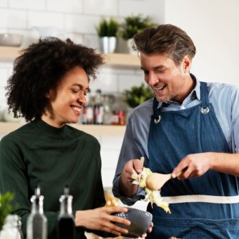 Couple preparing food in kitchen 1977225317