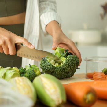 Lady cutting broccoli 2515357235
