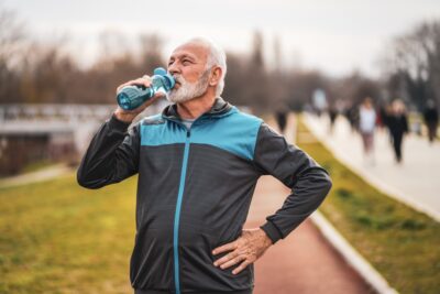 Older man hydrating after exercise lifestyle