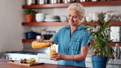Lady pouring orange juice 2490897211
