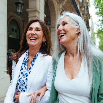 Friends laughing walking down street 2542892563