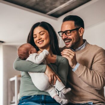 Parents holding baby 2357926283