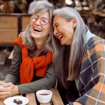 Two friends outside laughing 2340242067