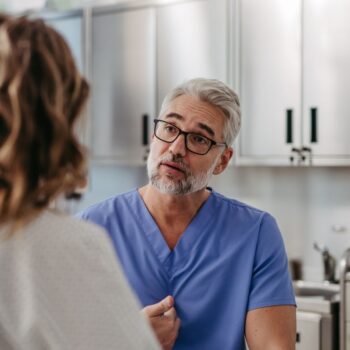 Male nurse speaking with patient 2415891409