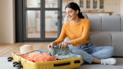 Lady packing suitcase 2409740119