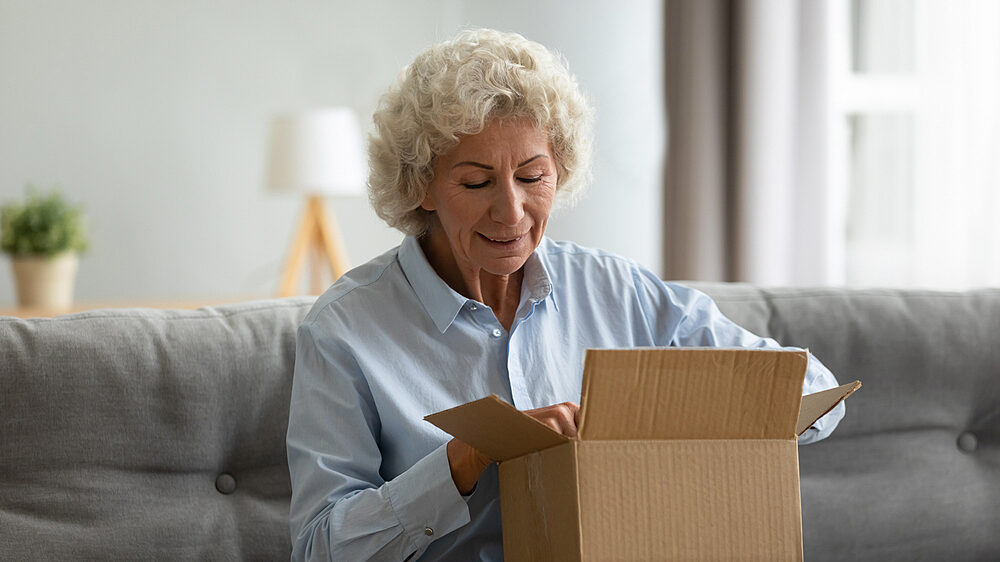 Lady opening parcel 1746127394